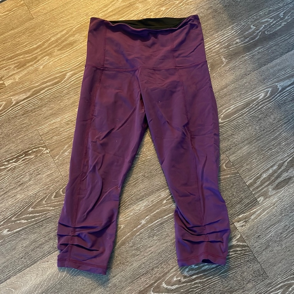 Purple high waisted Capri yoga pants.